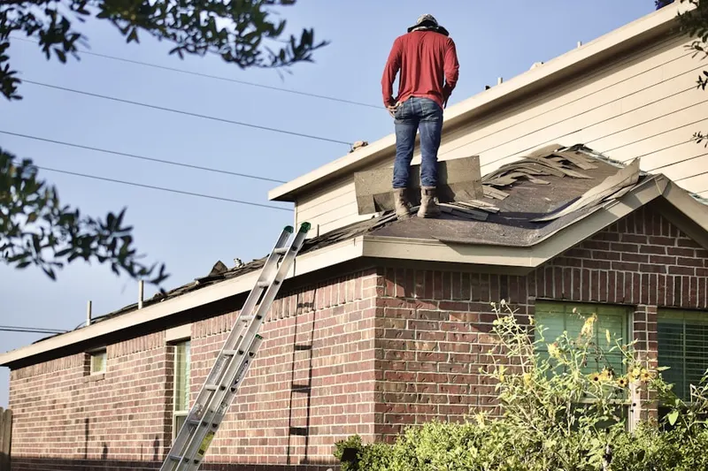 Professional roofer working on a residential roof in Embassy Lakes